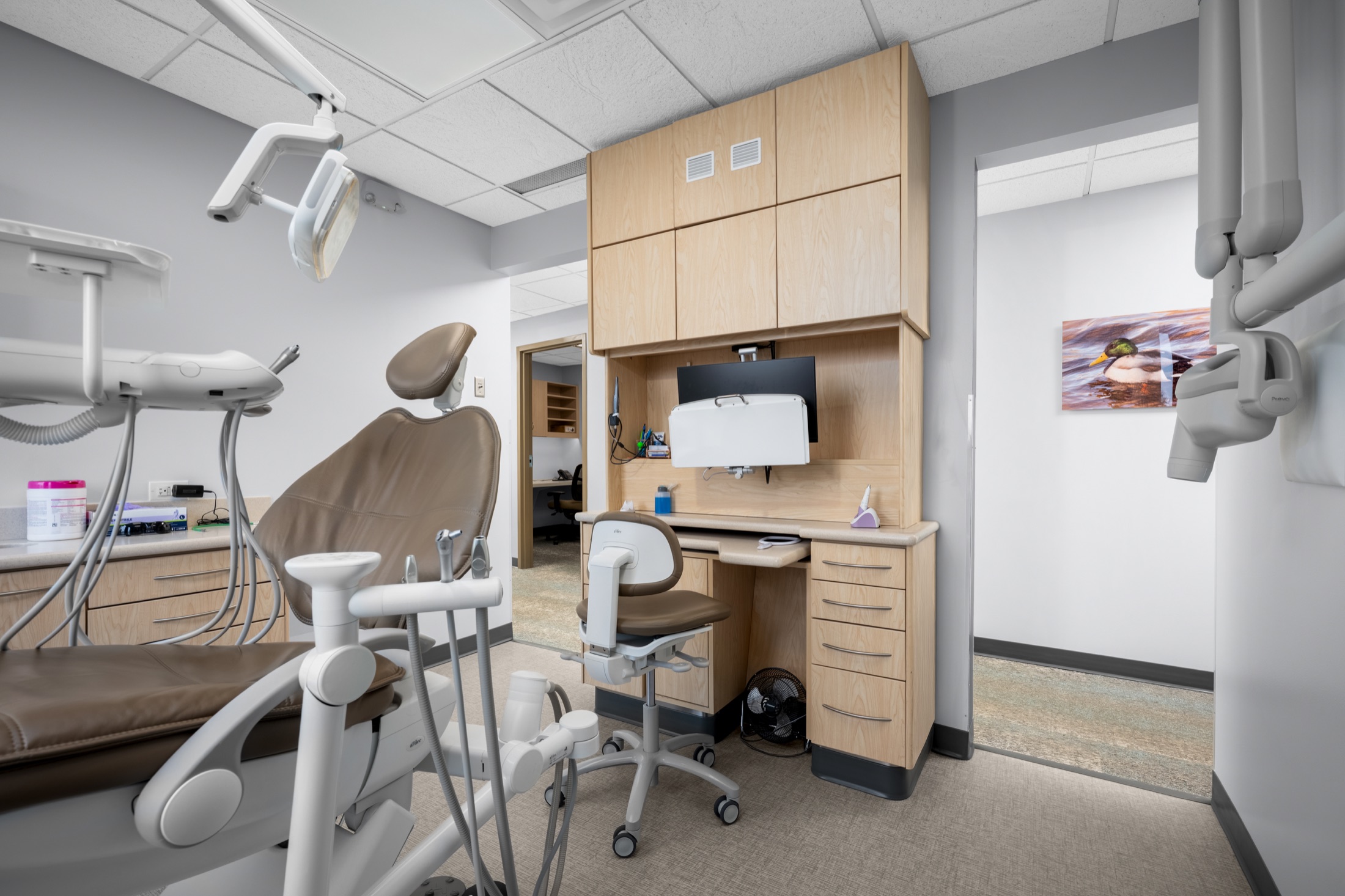 Dental treatment room with built-in cabinetry and imaging equipment